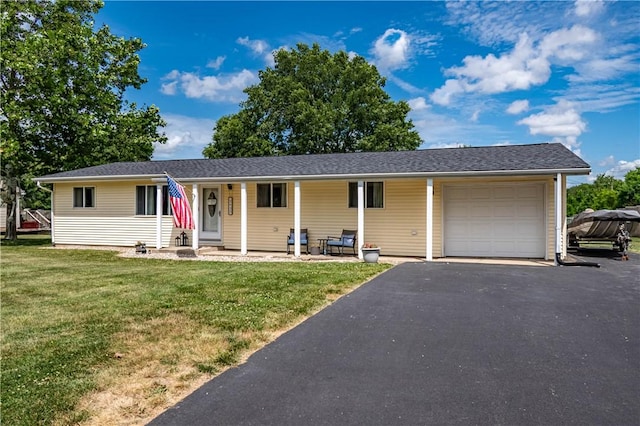 2430 Baker Ln, Decatur, IL 62526 - view of front of house with a garage, a front yard, asphalt driveway, and a porch
