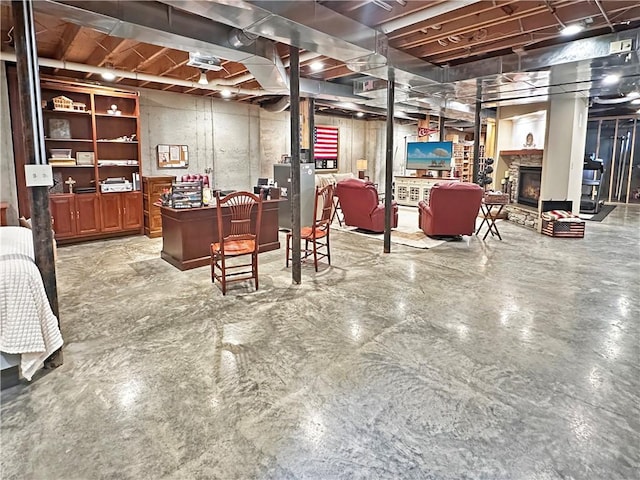 unfinished basement featuring a fireplace