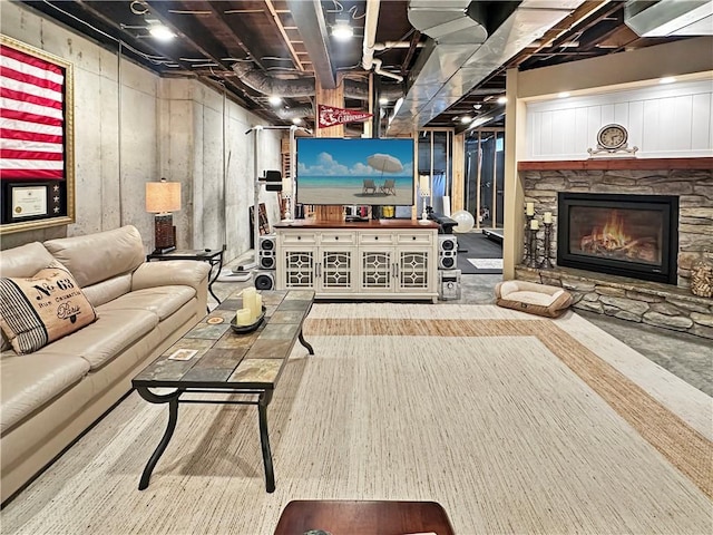 living area with a stone fireplace