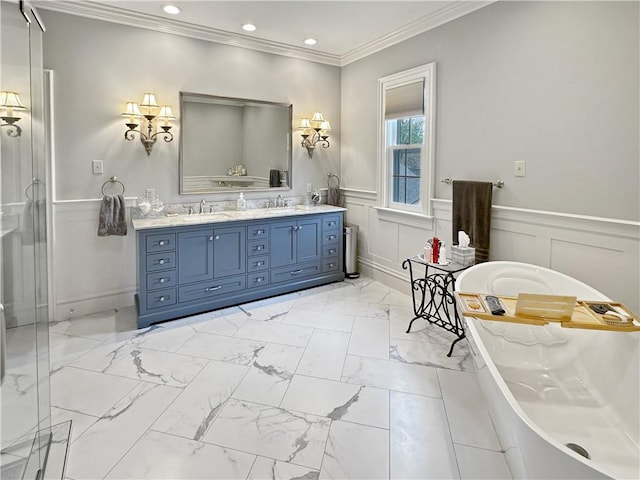 bathroom with double vanity, marble finish floors, a decorative wall, a freestanding bath, and wainscoting