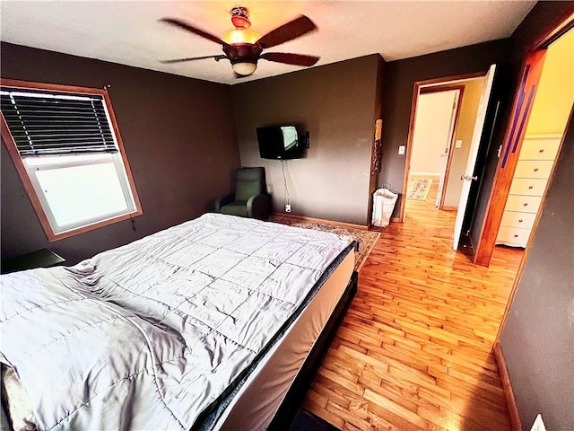 bedroom with ceiling fan and light hardwood / wood-style floors