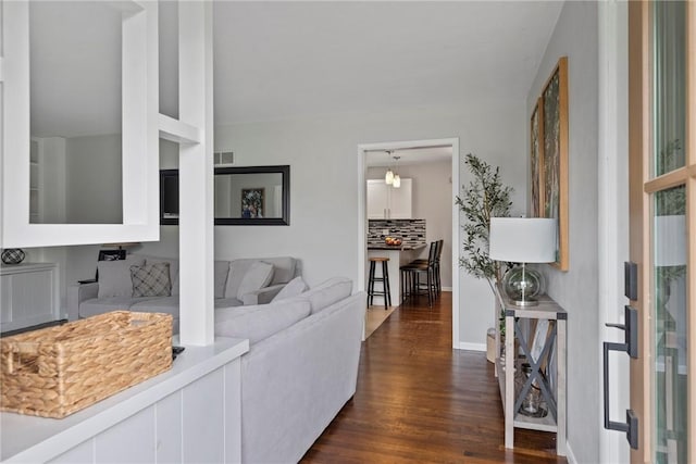 111 W 7th St, Pana, IL 62557 - living room featuring dark wood-type flooring and baseboards