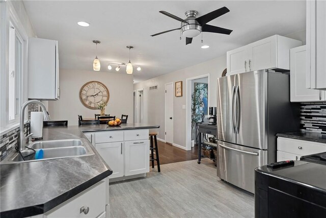 111 W 7th St, Pana, IL 62557 - kitchen featuring a sink, freestanding refrigerator, dark countertops, tasteful backsplash, and recessed lighting