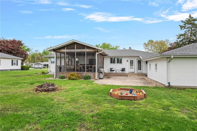 111 W 7th St, Pana, IL 62557 - back of house with an outdoor fire pit, a patio area, a sunroom, and a yard