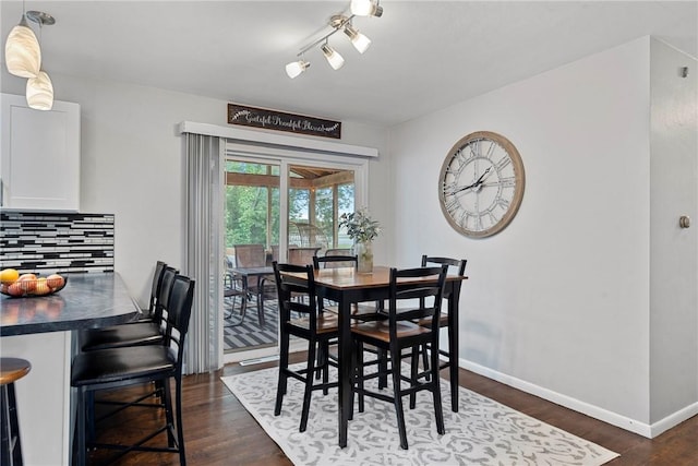 111 W 7th St, Pana, IL 62557 - dining area with baseboards and dark wood-style flooring