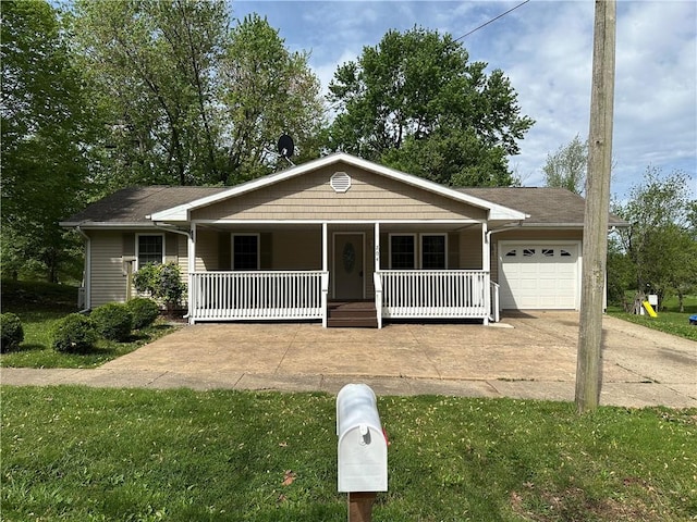 single story home with a garage, concrete driveway, a porch, and a front yard