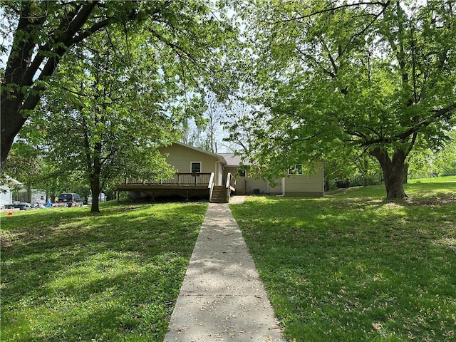 exterior space with a front lawn and a wooden deck