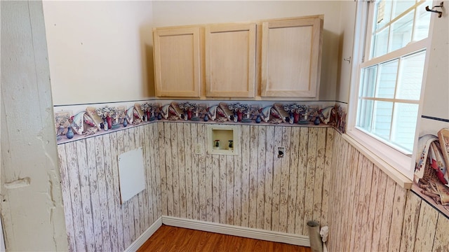 laundry area featuring plenty of natural light, washer hookup, wood finished floors, and hookup for an electric dryer