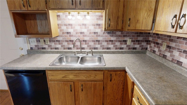 kitchen with a sink, light countertops, brown cabinetry, black dishwasher, and backsplash