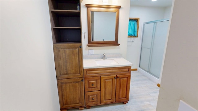 bathroom featuring vanity and a shower stall