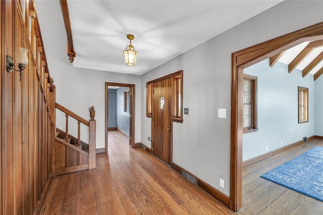 1655 N Vermilion St, Danville, IL 61832 - foyer featuring wood finished floors, a healthy amount of sunlight, baseboards, beamed ceiling, and stairs
