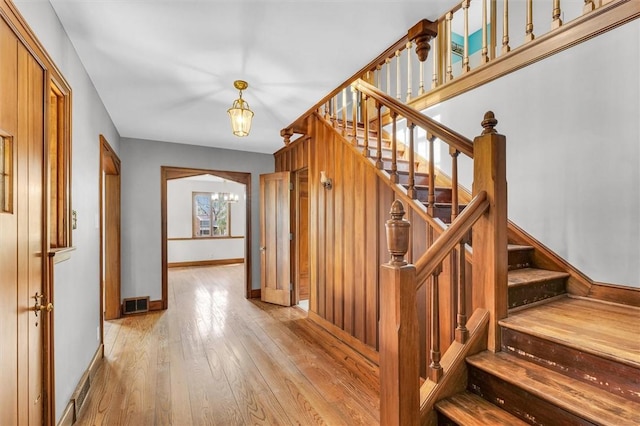 1655 N Vermilion St, Danville, IL 61832 - stairs with a chandelier, baseboards, visible vents, and hardwood / wood-style floors