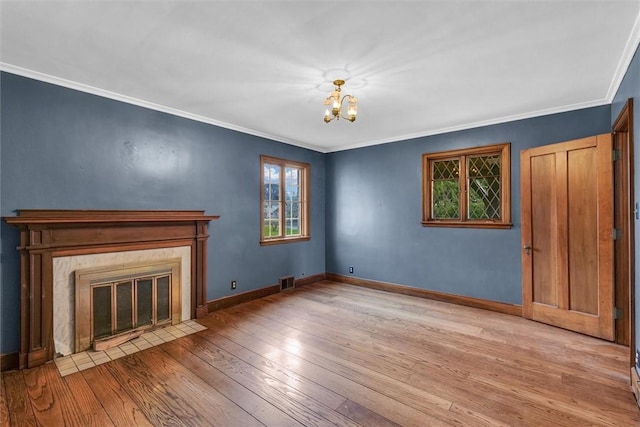 1655 N Vermilion St, Danville, IL 61832 - unfurnished living room featuring hardwood / wood-style floors, a notable chandelier, visible vents, baseboards, and ornamental molding