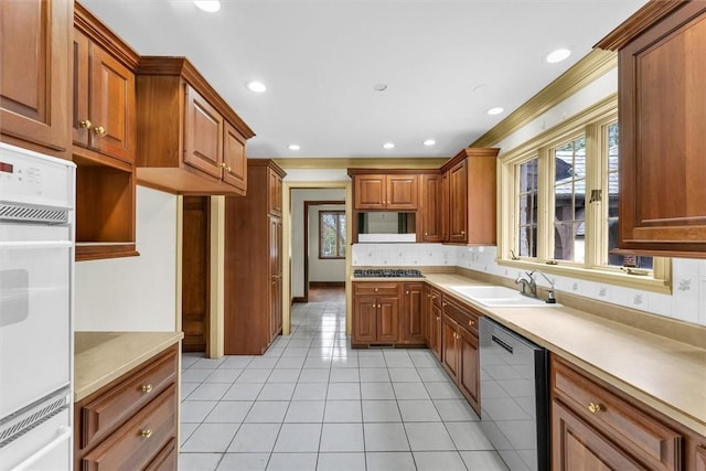 1655 N Vermilion St, Danville, IL 61832 - kitchen featuring light tile patterned flooring, a sink, backsplash, brown cabinets, and stainless steel appliances