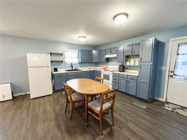 1402 N Howard St, Robinson, IL 62454 - kitchen featuring white appliances, open shelves, under cabinet range hood, dark wood finished floors, and light countertops