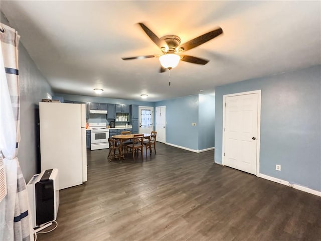 1402 N Howard St, Robinson, IL 62454 - kitchen featuring white appliances, a ceiling fan, dark wood-style floors, under cabinet range hood, and light countertops