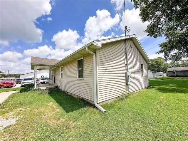 1402 N Howard St, Robinson, IL 62454 - view of side of home with a lawn and a patio area