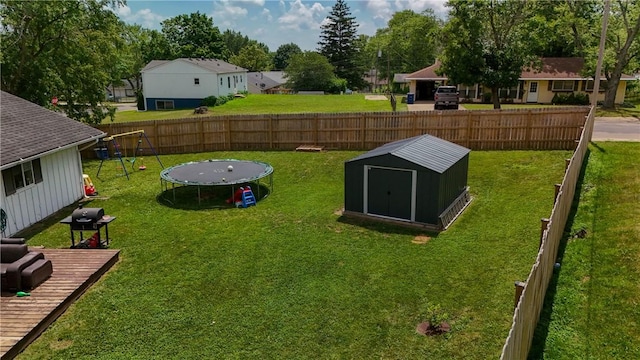 1516 Eastview Ave, Danville, IL 61832 - fenced backyard featuring a trampoline, a playground, and a storage shed