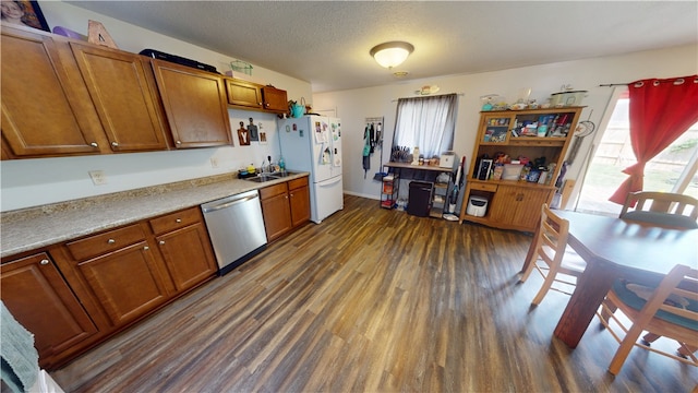 1516 Eastview Ave, Danville, IL 61832 - kitchen with stainless steel dishwasher, white refrigerator with ice dispenser, dark wood-style floors, healthy amount of natural light, and a textured ceiling