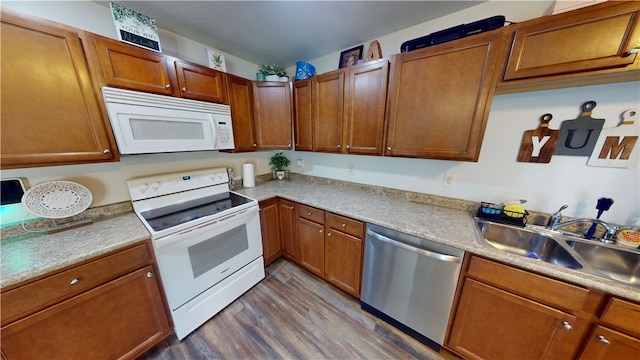 1516 Eastview Ave, Danville, IL 61832 - kitchen featuring white appliances, dark wood-style flooring, light countertops, and brown cabinets