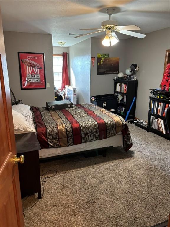 carpeted bedroom featuring ceiling fan