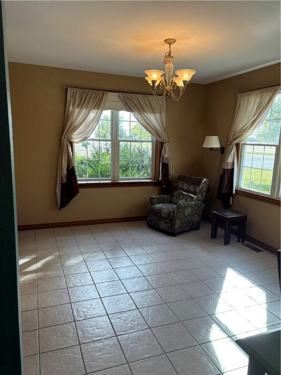 sitting room featuring light tile patterned flooring, an inviting chandelier, and a wealth of natural light