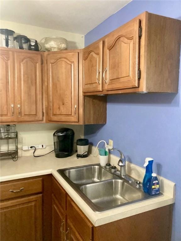 3117 Oak Ave, Mattoon, IL 61938 - kitchen featuring light countertops, a sink, and brown cabinets