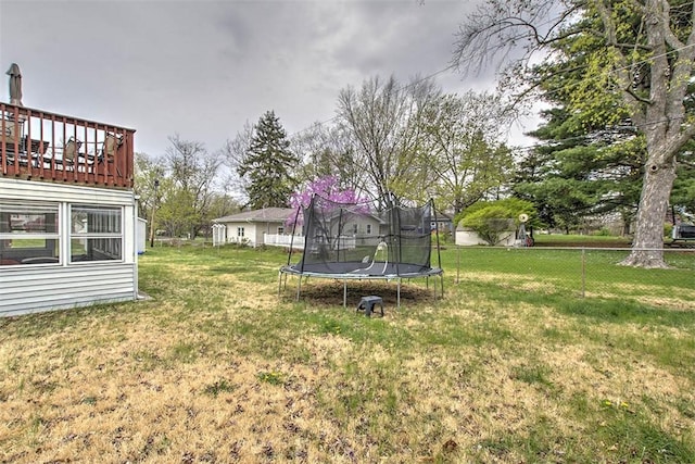 view of yard featuring fence and a trampoline