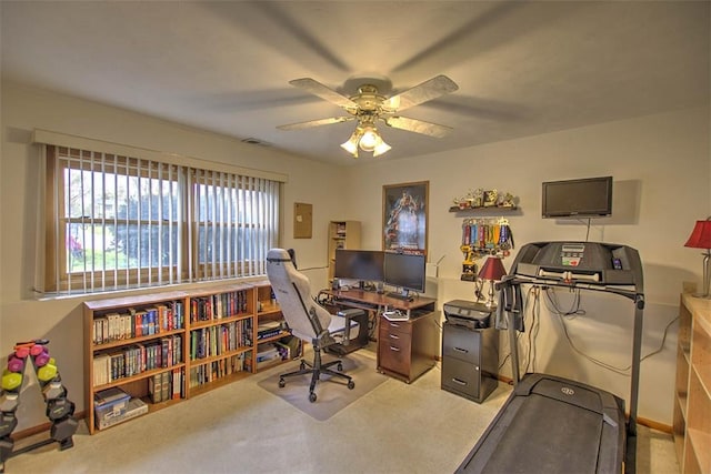 carpeted office with a ceiling fan and visible vents