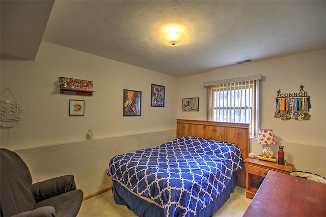bedroom with light colored carpet and visible vents
