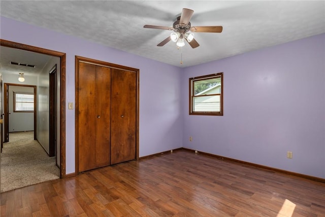 1009 Henrietta St, Effingham, IL 62401 - unfurnished bedroom with wood finished floors, a closet, and a ceiling fan