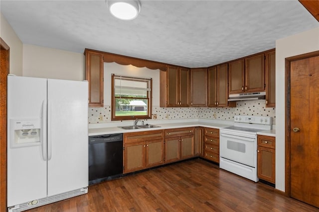 1009 Henrietta St, Effingham, IL 62401 - kitchen with white appliances, under cabinet range hood, backsplash, dark wood-style floors, and a textured ceiling