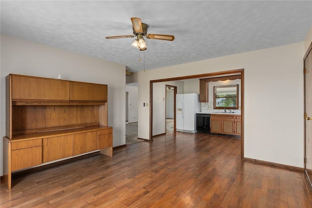1009 Henrietta St, Effingham, IL 62401 - unfurnished living room with ceiling fan and dark wood-style flooring