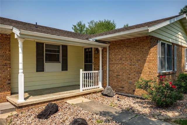 1009 Henrietta St, Effingham, IL 62401 - view of exterior entry featuring brick siding, roof with shingles, and covered porch