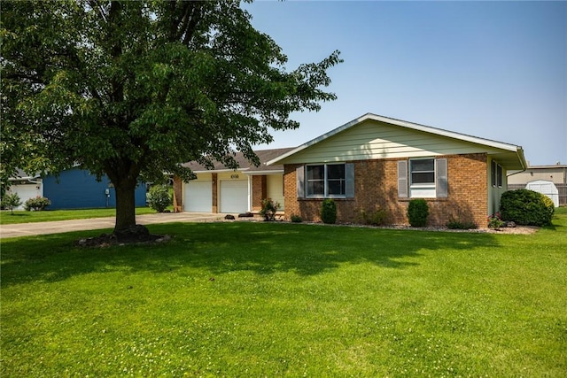 1009 Henrietta St, Effingham, IL 62401 - ranch-style home featuring driveway, an attached garage, a front yard, and brick siding