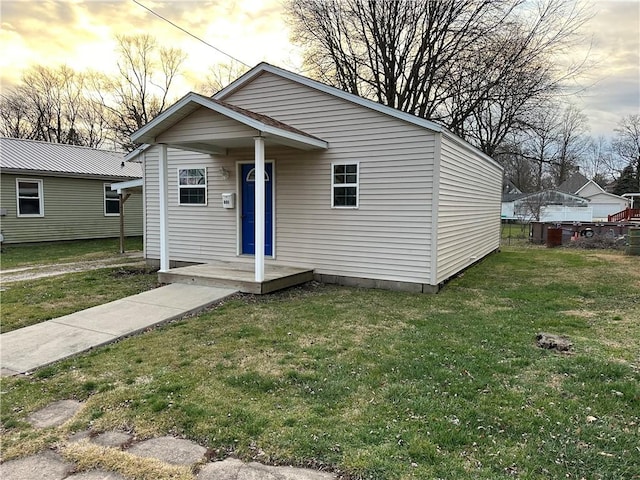 bungalow-style house featuring a yard