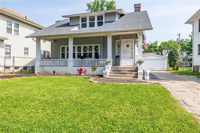 1440 W Decatur St, Decatur, IL 62522 - bungalow-style home featuring a chimney, an outdoor structure, a porch, a detached garage, and a front lawn