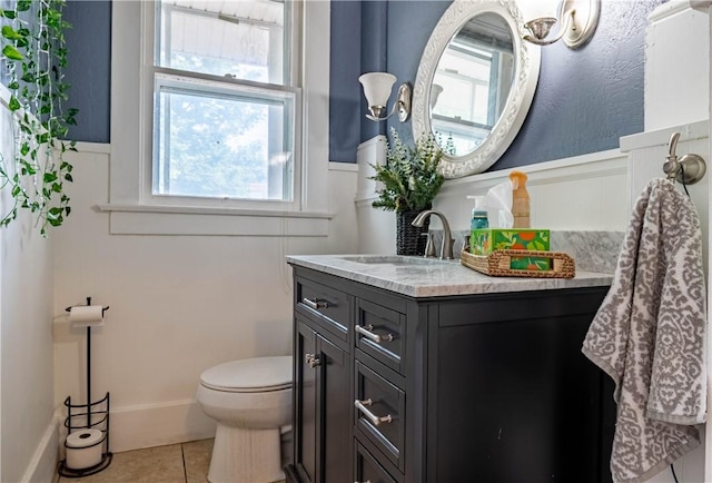 1440 W Decatur St, Decatur, IL 62522 - bathroom featuring tile patterned floors, vanity, and wainscoting