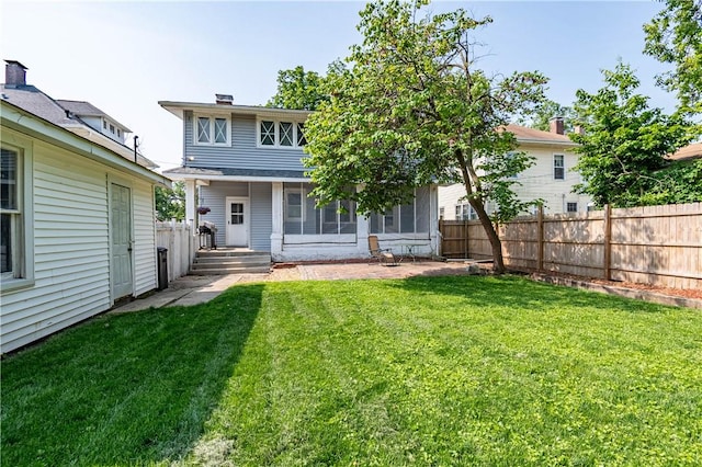 1440 W Decatur St, Decatur, IL 62522 - rear view of house featuring a fenced backyard and a sunroom