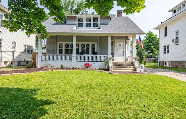 1440 W Decatur St, Decatur, IL 62522 - view of front of home with a porch, a chimney, a front lawn, and a shingled roof