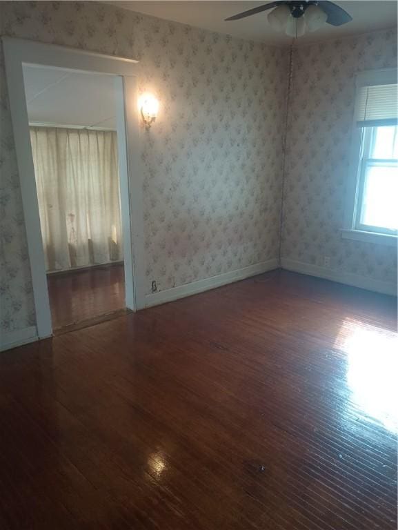 spare room with hardwood / wood-style flooring and ceiling fan