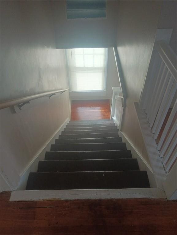 staircase with wood-type flooring