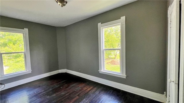 unfurnished room with hardwood / wood-style floors