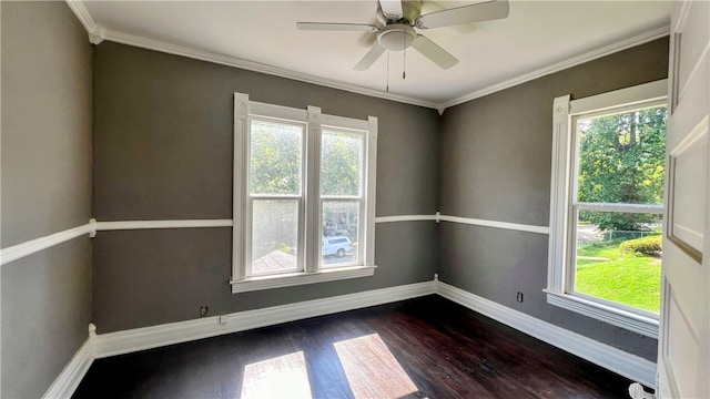 unfurnished room featuring plenty of natural light, dark hardwood / wood-style floors, ornamental molding, and ceiling fan