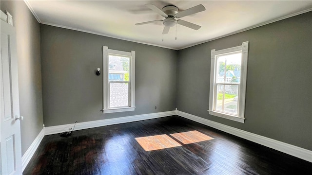 spare room with ornamental molding, ceiling fan, and dark wood-type flooring