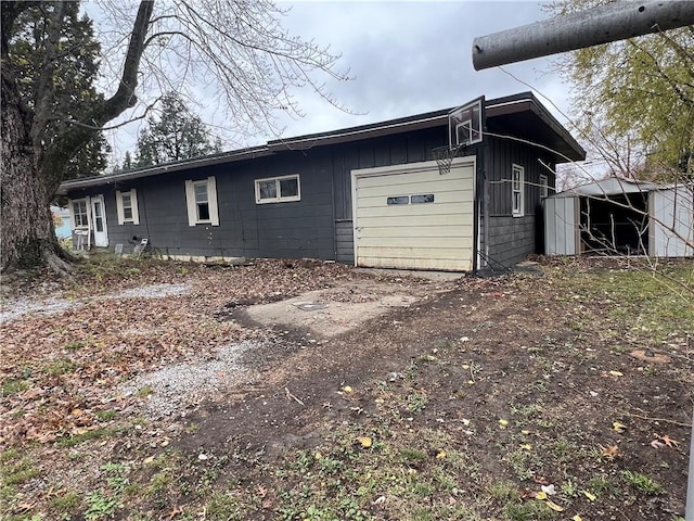 902 N Robb St, Robinson, IL 62454 - view of side of property with a garage and board and batten siding
