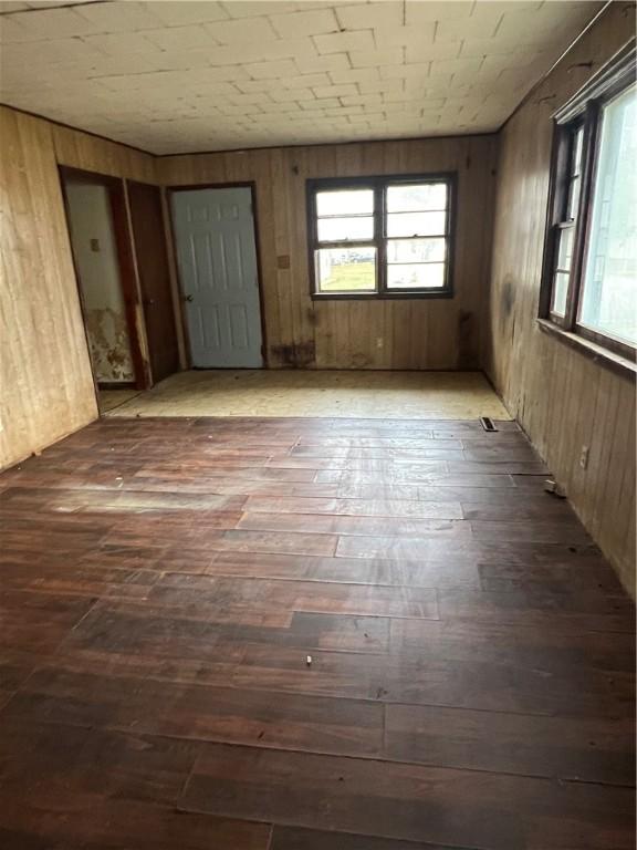902 N Robb St, Robinson, IL 62454 - spare room featuring hardwood / wood-style floors and wood walls