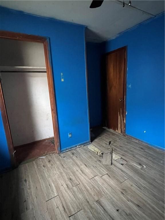 902 N Robb St, Robinson, IL 62454 - unfurnished bedroom featuring wood finished floors, a closet, and ceiling fan