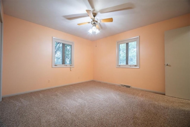 carpeted spare room with ceiling fan