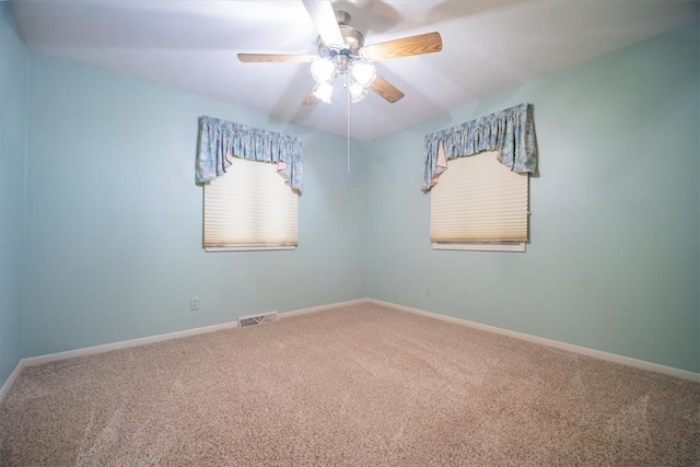 empty room featuring ceiling fan and carpet floors